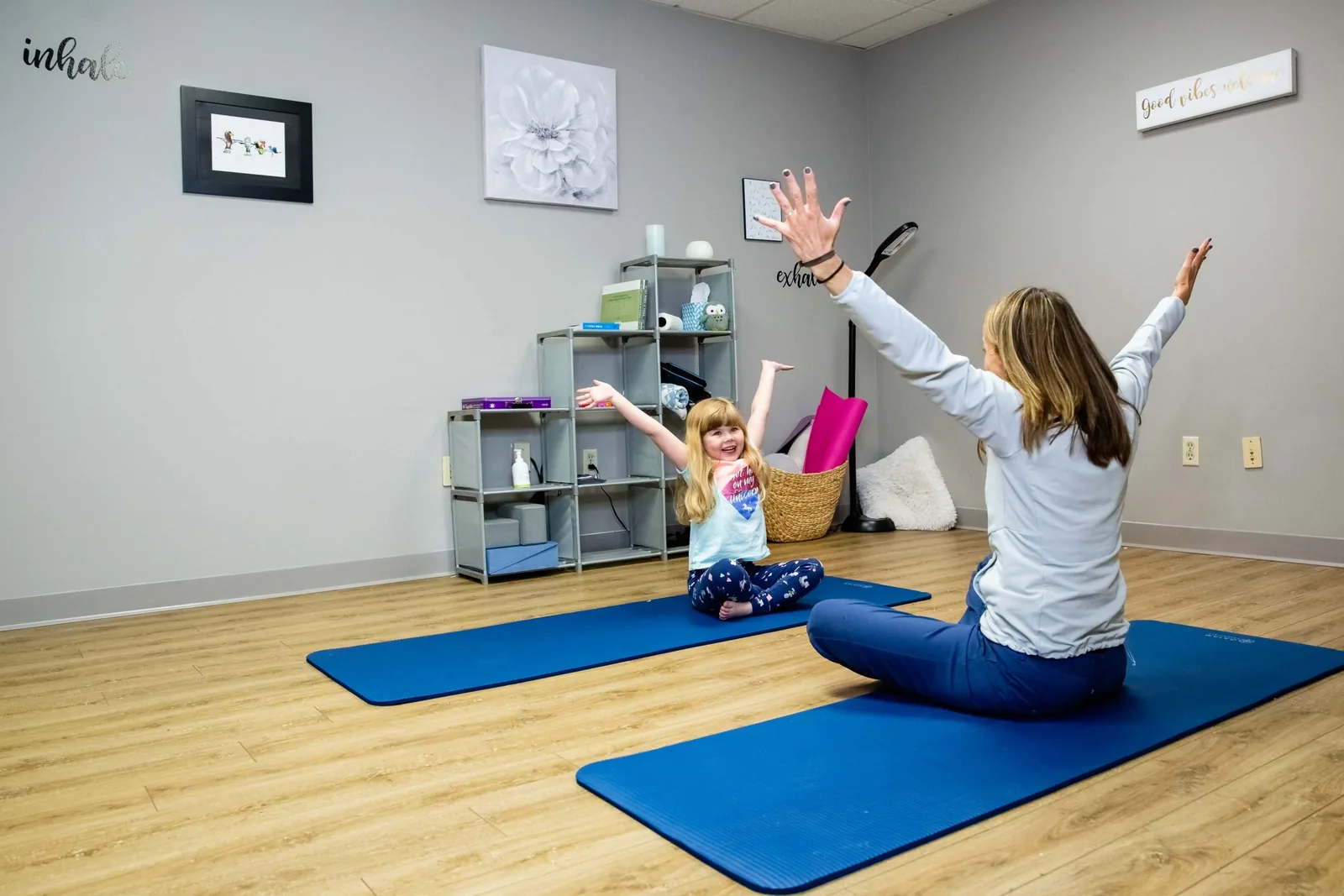 A Wild Roots therapist working alongside a caregiver and children